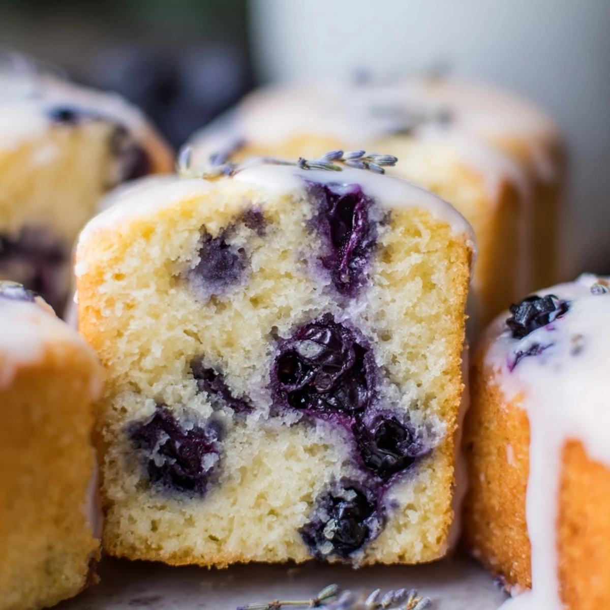 Homemade Lavender Blueberry Tea Cakes arranged on a floral plate, ready for an elegant afternoon tea party.