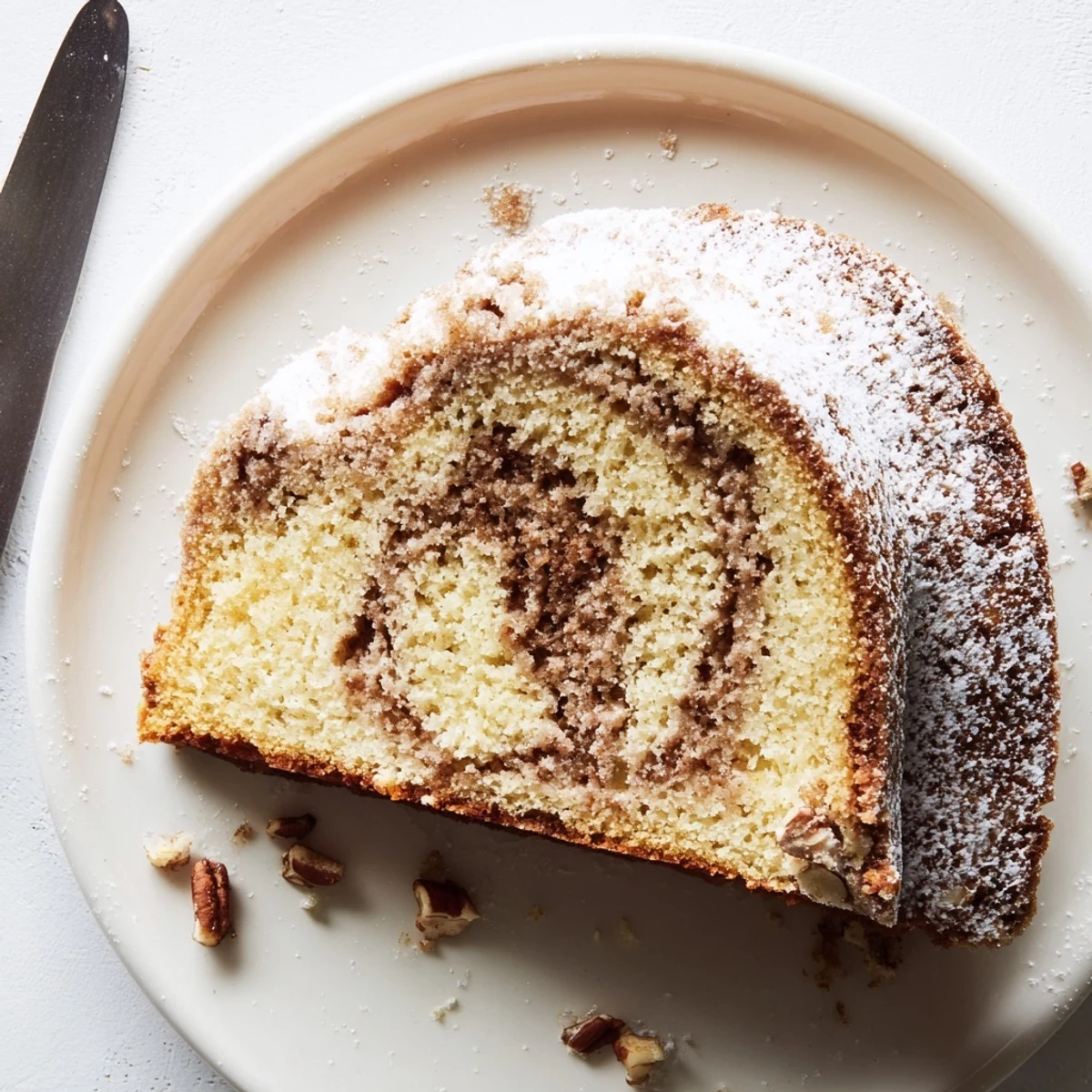 Golden breakfast Bundt coffee cake with cinnamon swirl and powdered sugar dusting