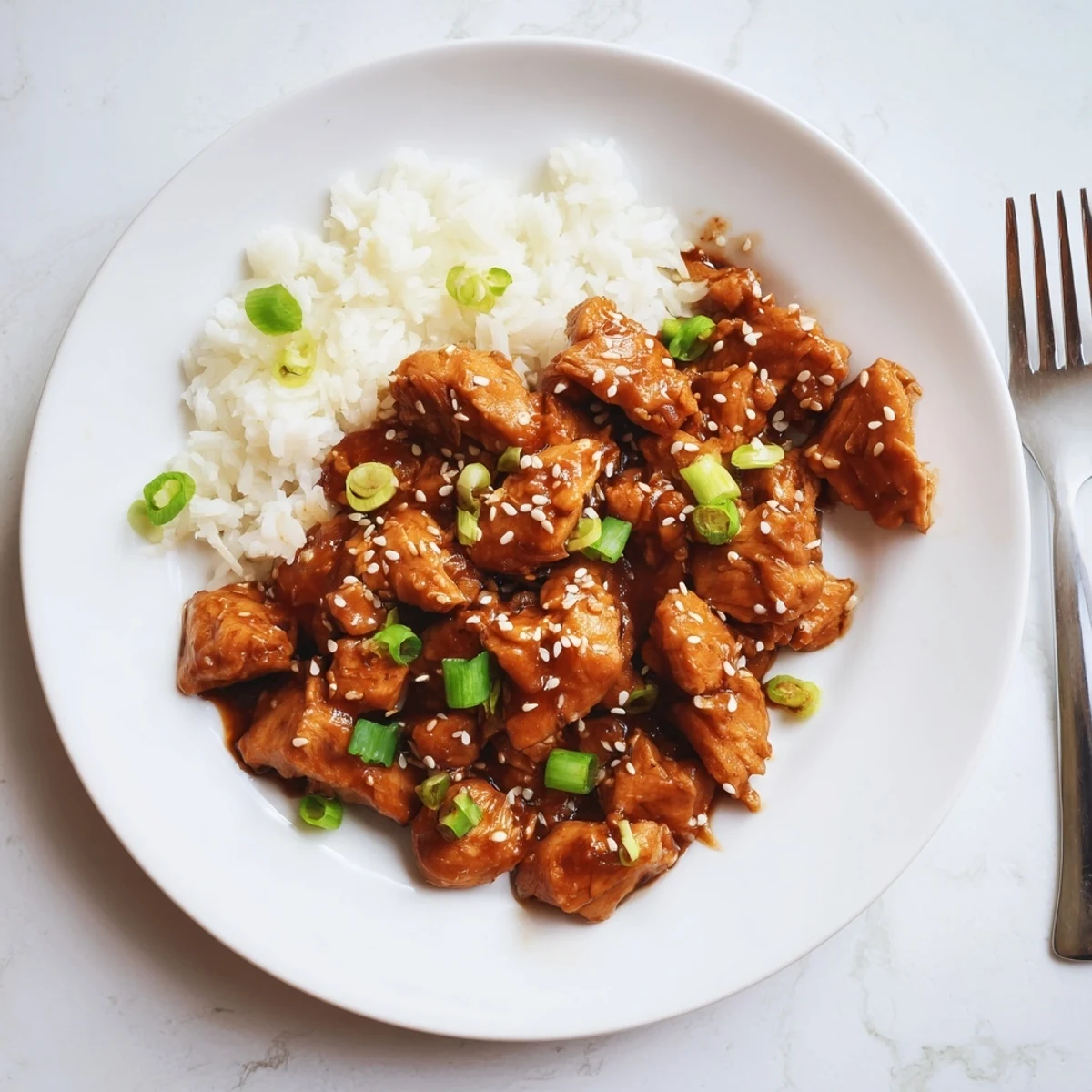 Tender Mongolian chicken pieces slow cooked with garlic ginger sauce and topped with fresh green onions