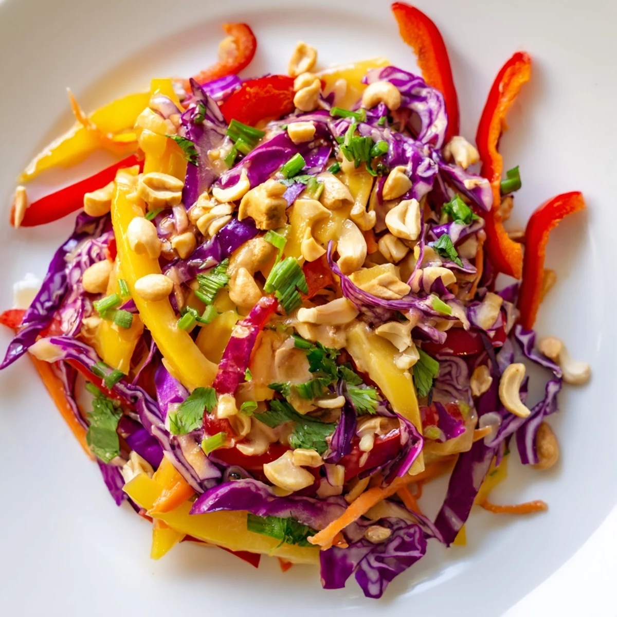 Colorful tropical mango slaw topped with crunchy cashews and fresh green onions.