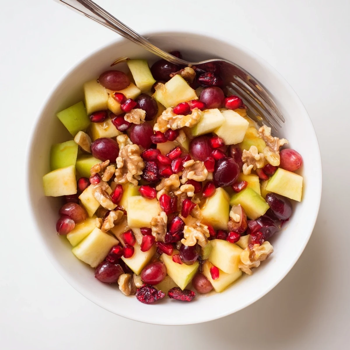 Bowl of fresh Minute Fall Fruit Salad tossed with citrus honey dressing and walnuts