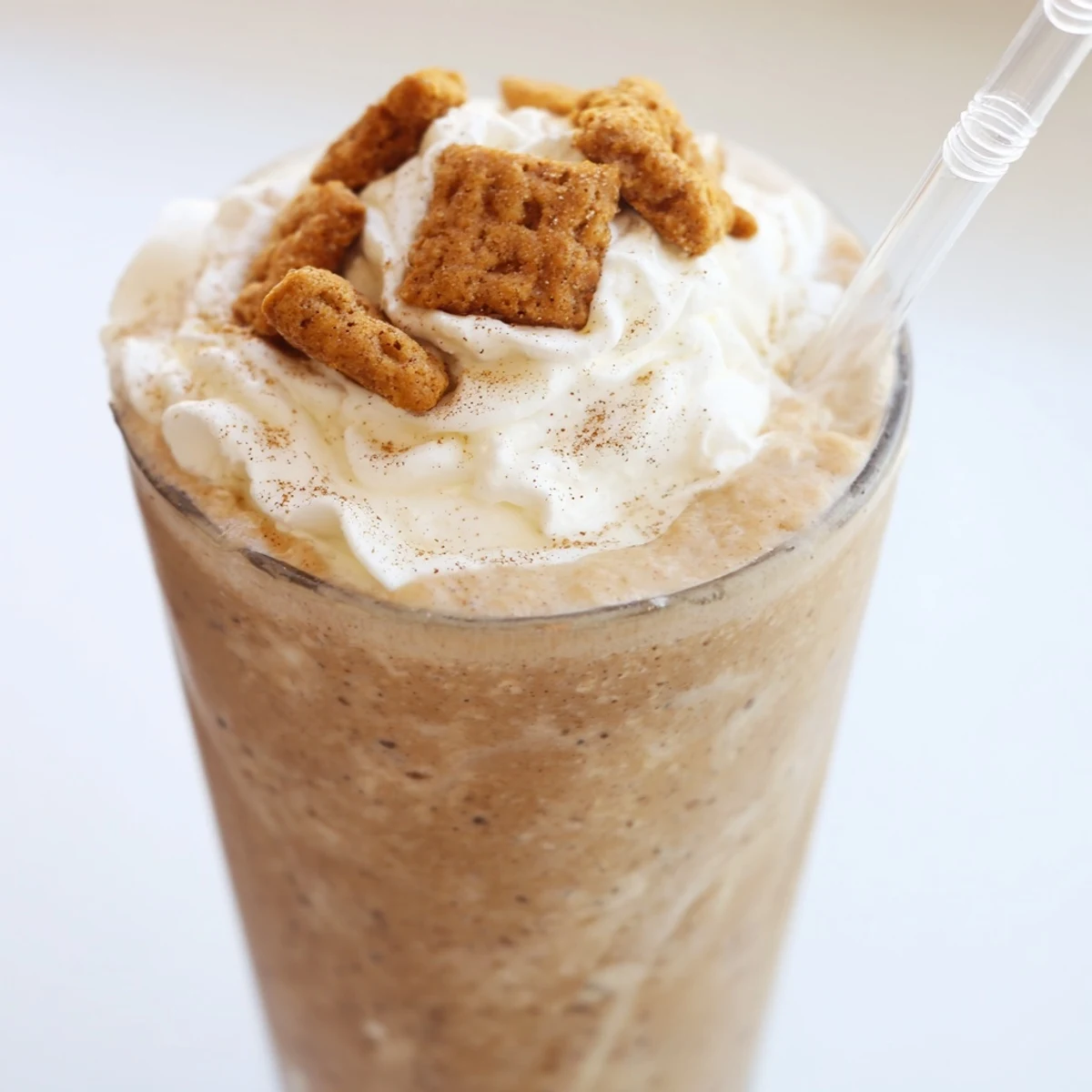 Thick blended coffee drink featuring Cinnamon Toast Crunch cereal with cinnamon dusting and straw
