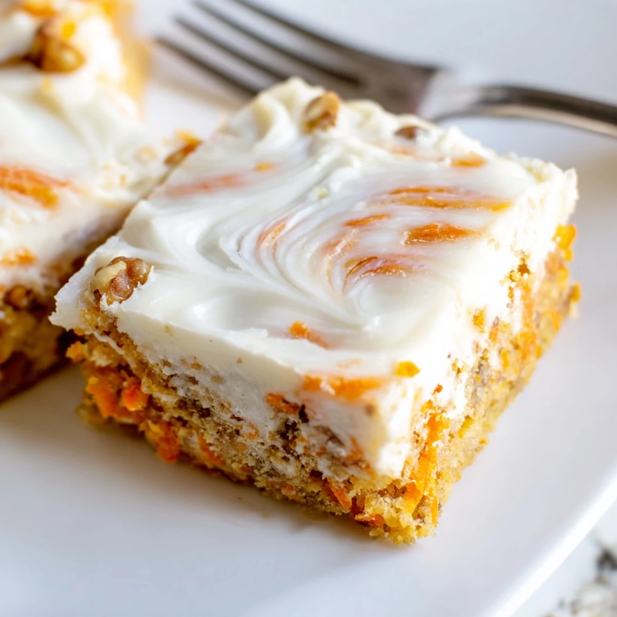 Moist carrot cake bars with cream cheese swirl cooling on wire rack