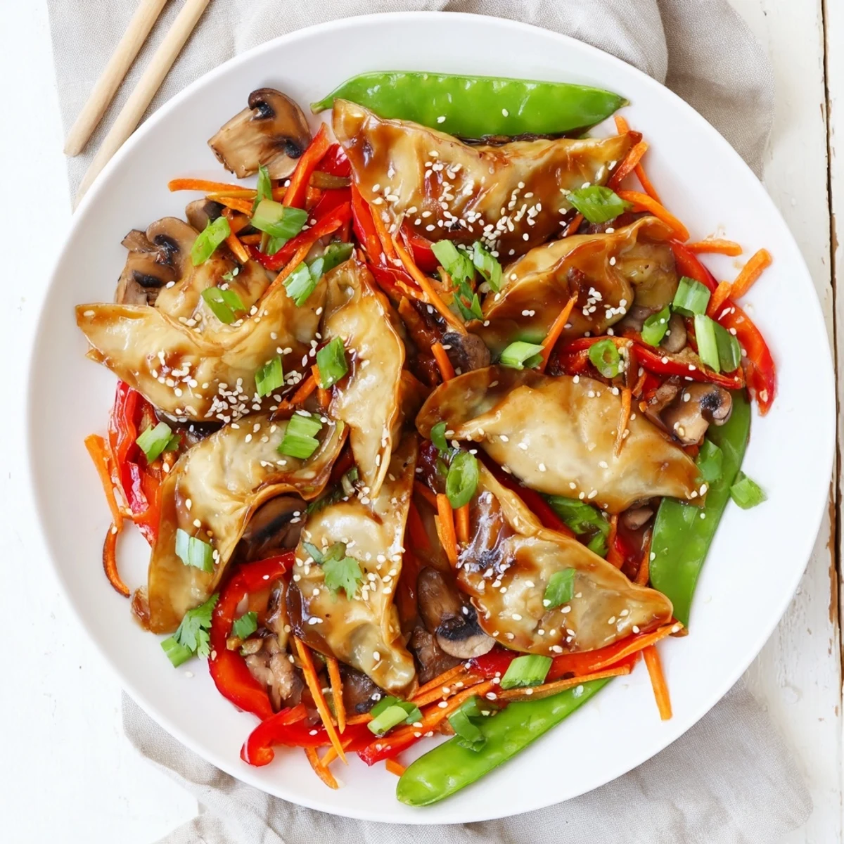 Golden potsticker stir fry with colorful bell peppers, snap peas, and savory soy sauce