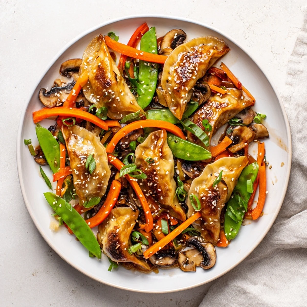 Delicious potsticker stir fry garnished with sesame seeds, cilantro, and tender crisp vegetables