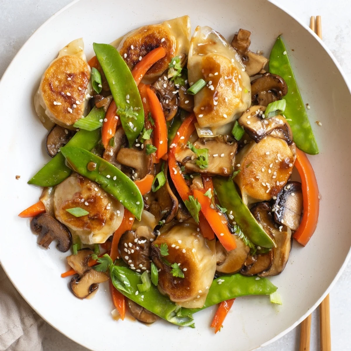 Crispy potstickers tossed with fresh vegetables in a wok for an easy Asian fusion dinner