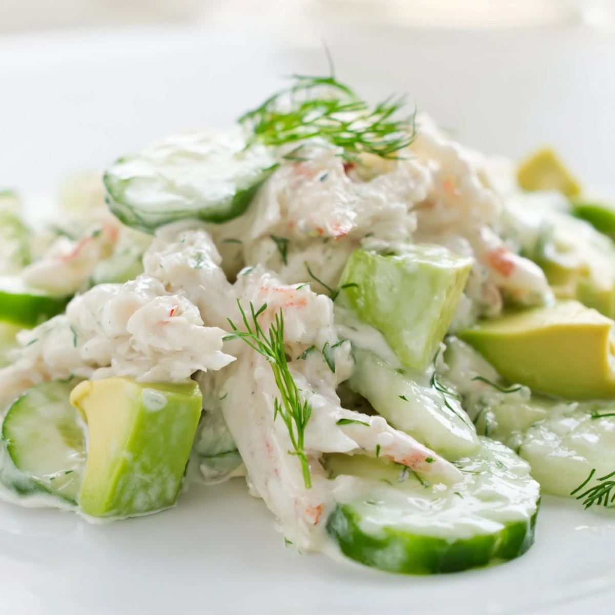 Chilled cucumber salad with crab meat featuring crisp slices, tender seafood, and tangy herb dressing