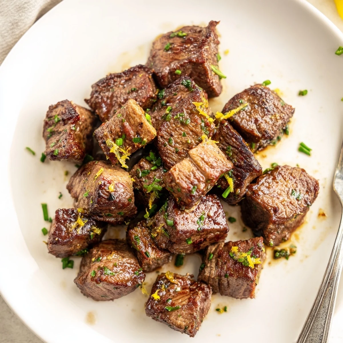 Cowboy Butter Steak Bites sizzling in skillet, golden sear and herb butter.