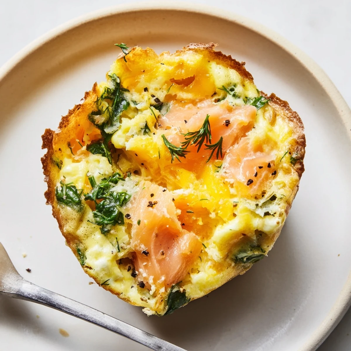 Warm Smoked Salmon Egg Muffins served on a plate with lemon  