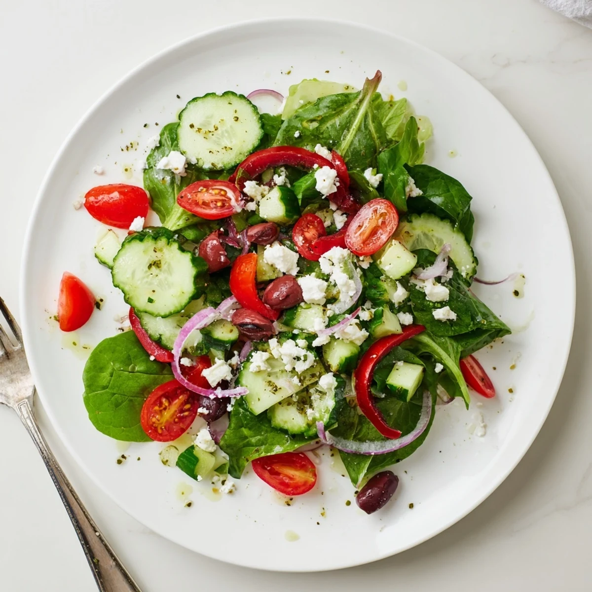 Bright summer bowl showing the Fresh Salad Recipe topped with tangy feta.