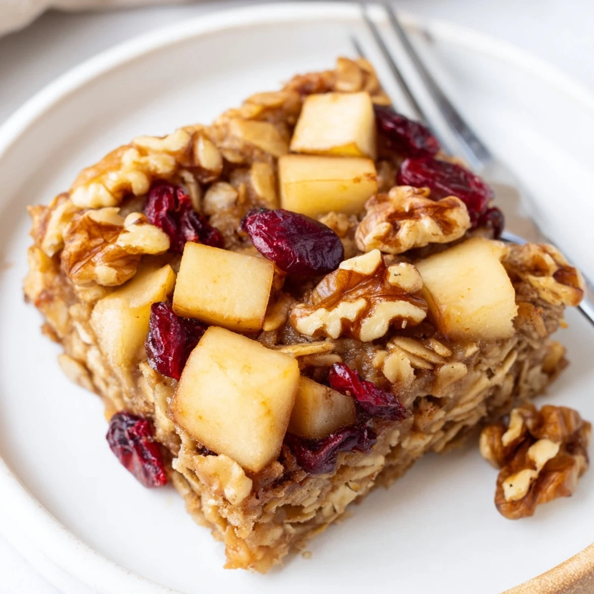 Slice of Delicious Apple Cinnamon Oatmeal Bake Recipe For Mornings steaming, nutty aroma