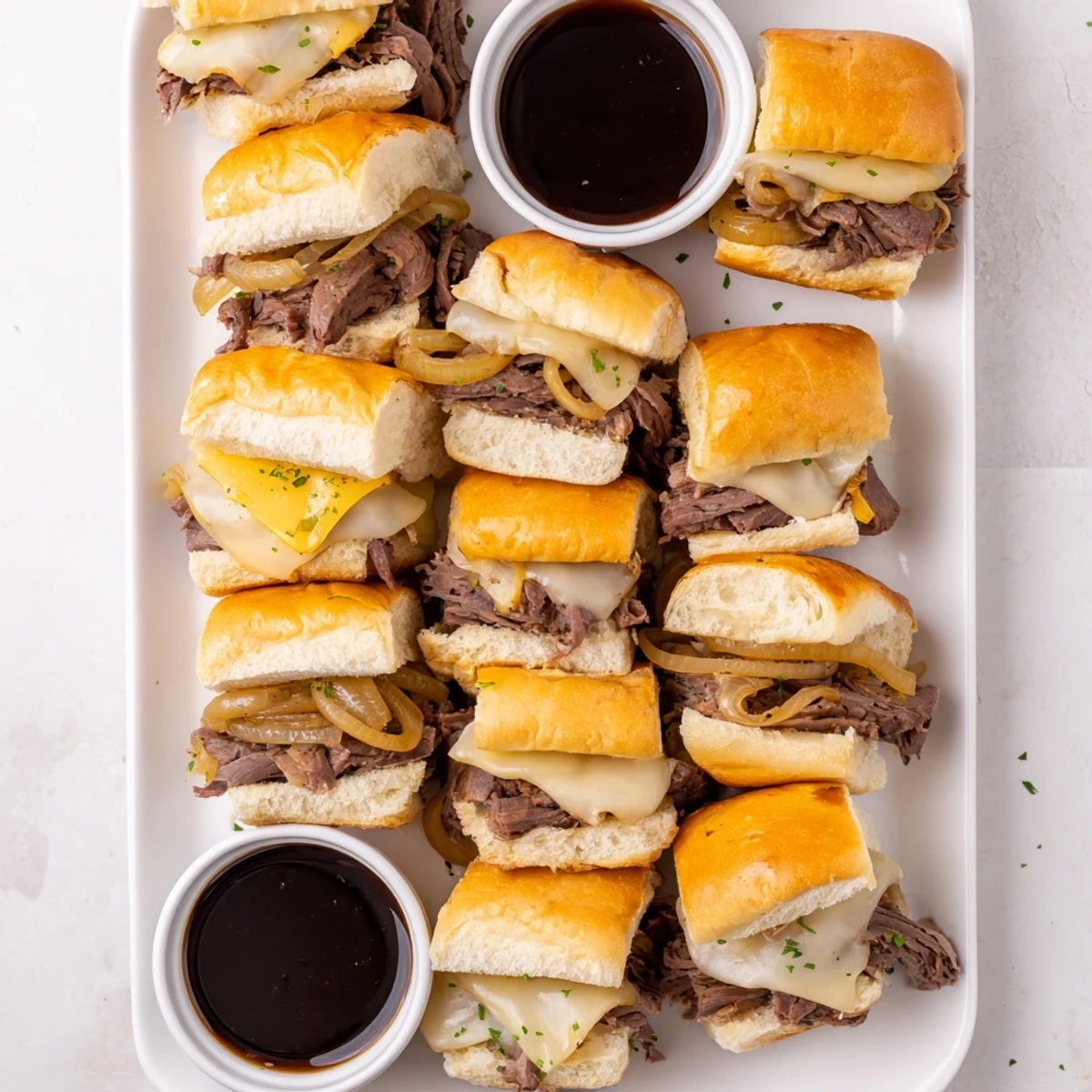 Golden French dip sliders with melted provolone and savory beef on toasted rolls