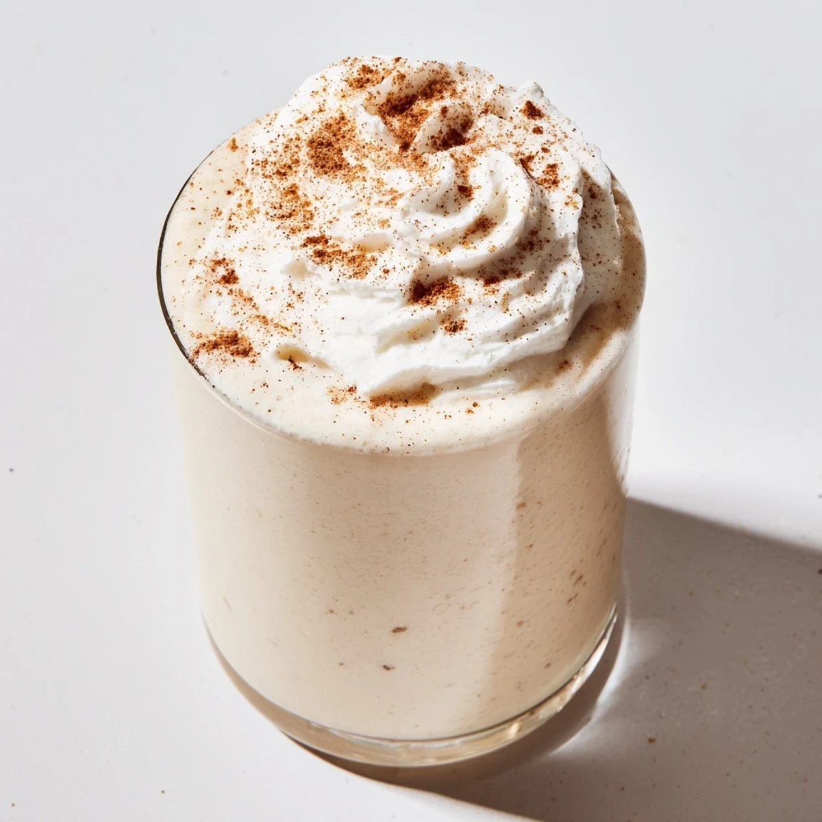 Golden keto eggnog delight served chilled with sprinkled nutmeg for holiday celebrations