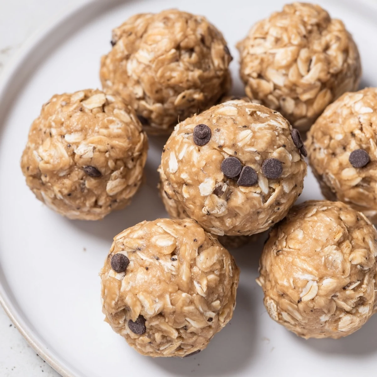 Bite-sized no-bake peanut butter energy balls rolled in oats and ready for snacking