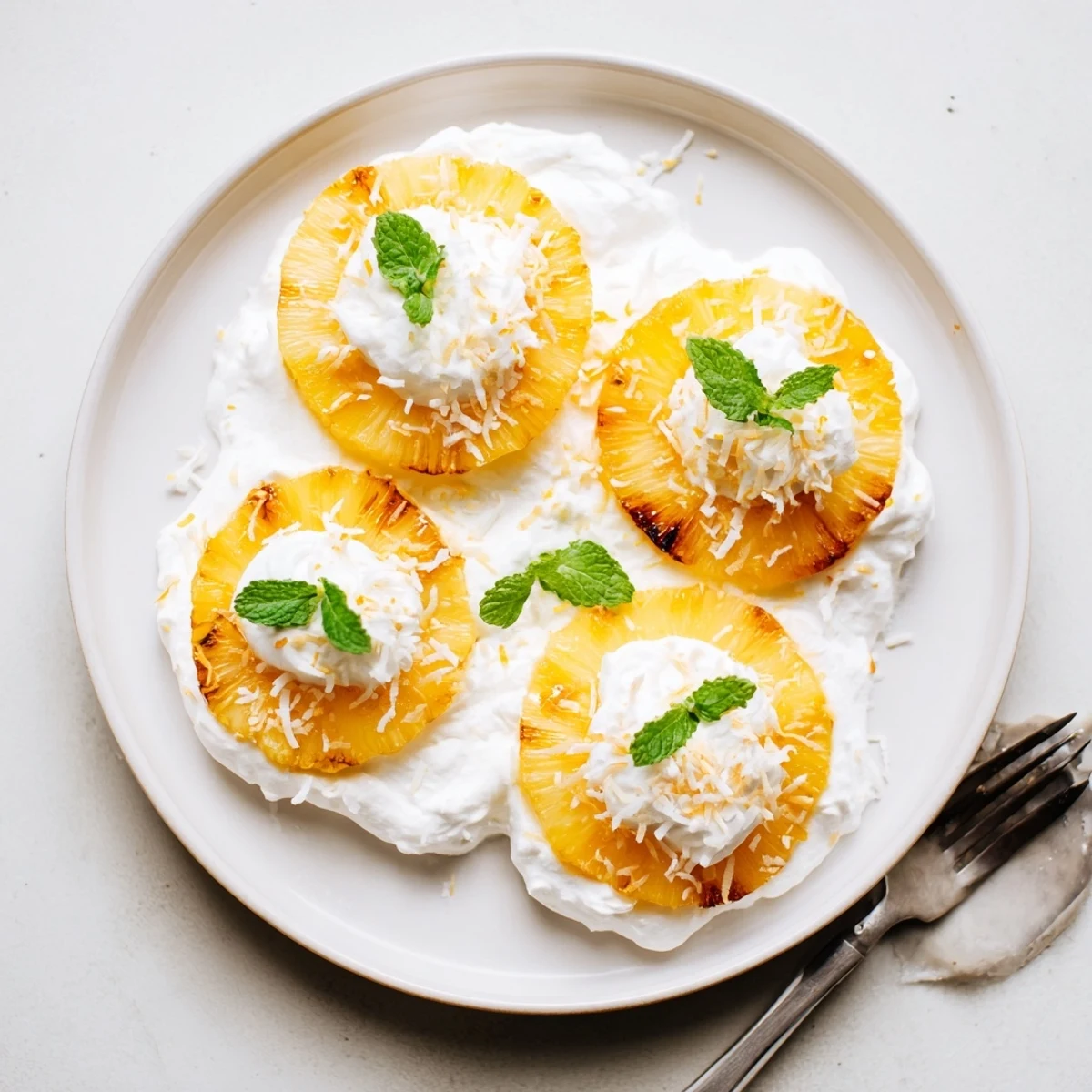 Party-ready Creamy Citrus Grilled Pineapple, smoky-sweet rings topped with bright orange zest.
