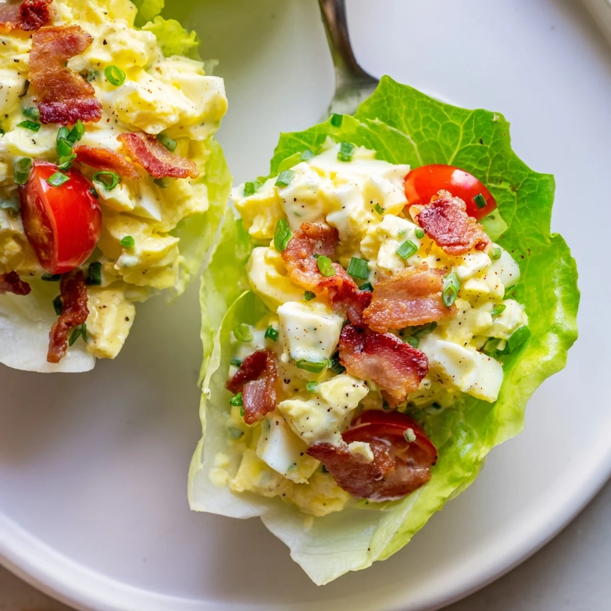 Fresh BLT Egg Salad Lettuce Wraps served on butter lettuce, chilled iced tea.
