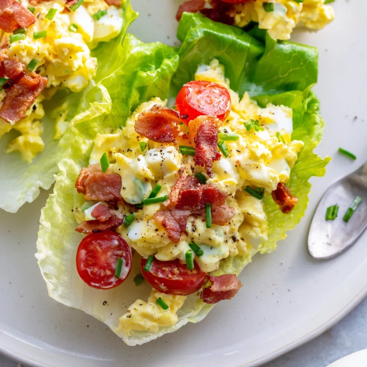 BLT Egg Salad Lettuce Wraps with creamy yolk, crispy bacon, bright tomatoes.