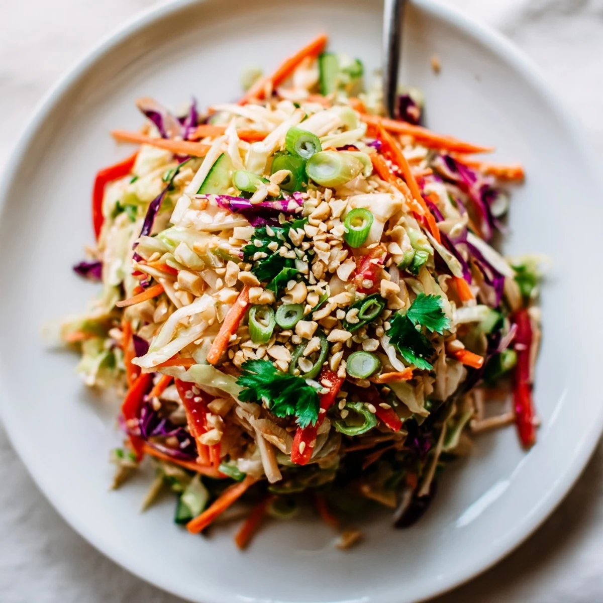 Bowl of Asian Cabbage Salad tossed in tangy sesame-ginger dressing, topped with sesame