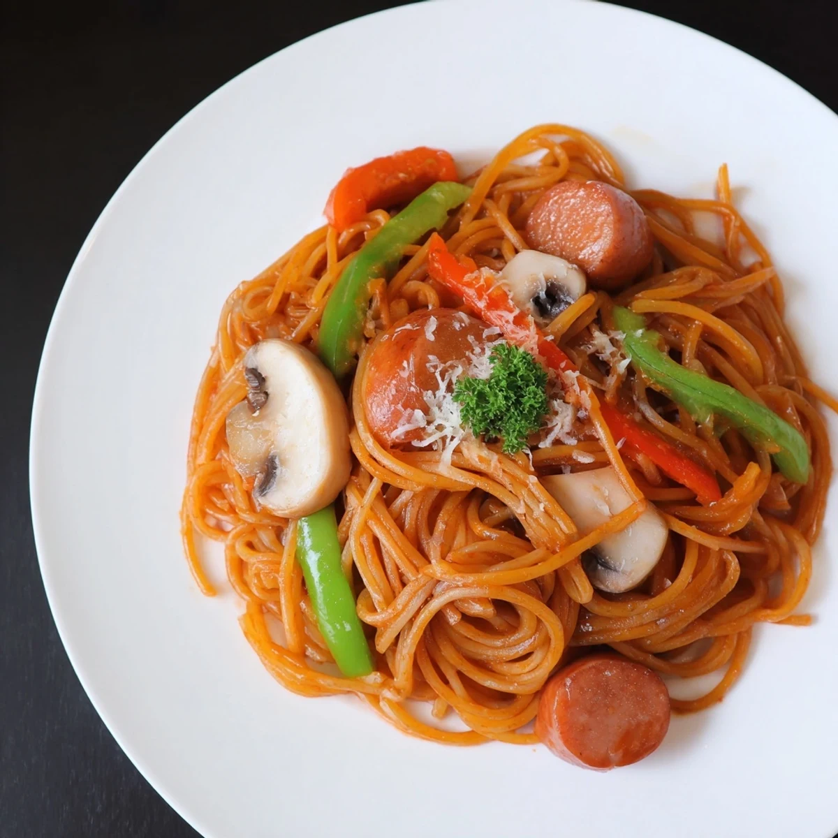 Plated steaming with parsley and Parmesan, Spaghetti Napolitan invites cozy bites