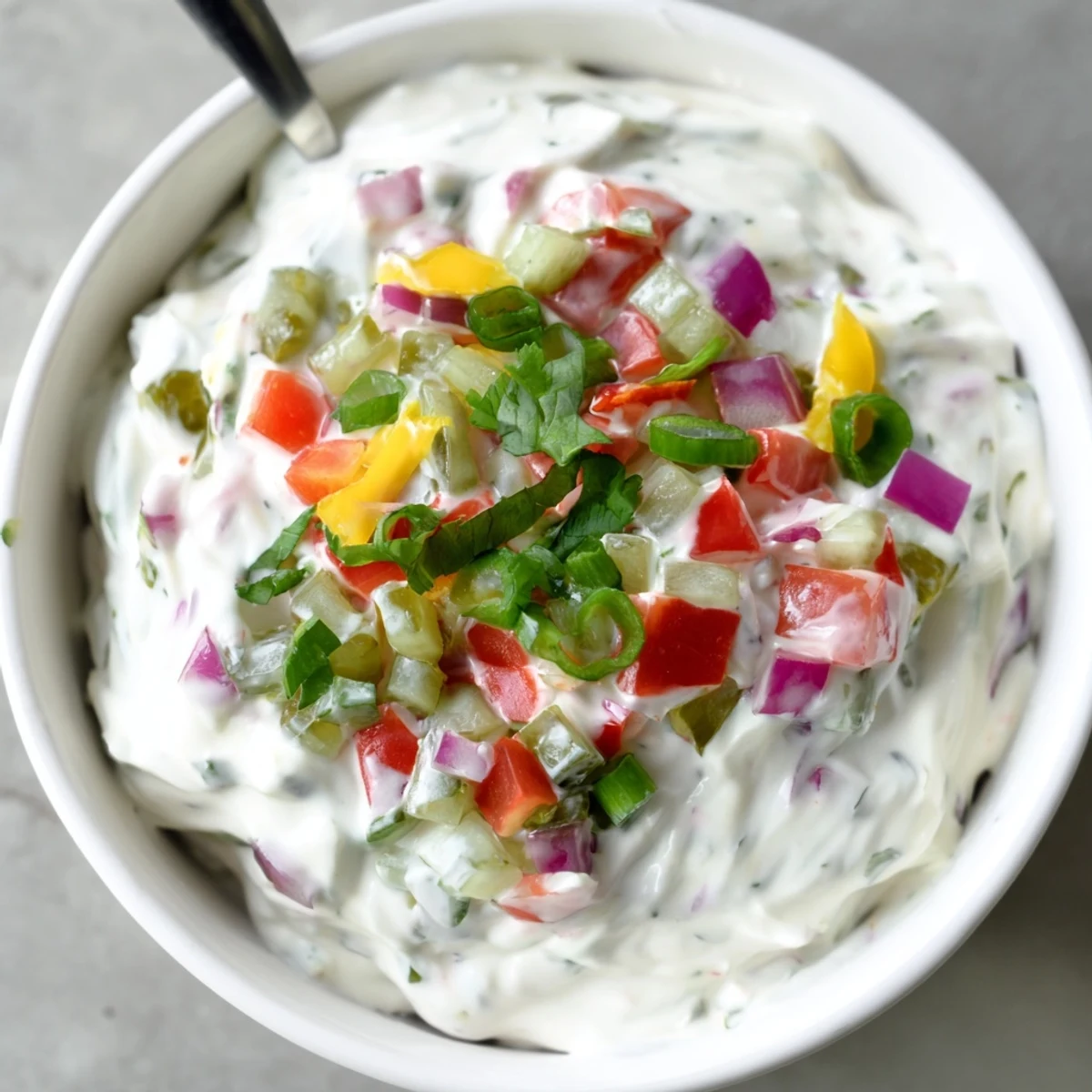 Bowl of zesty Grillos Pickle De Gallo Ranch Dip surrounded by tortilla chips and fresh vegetable crudités