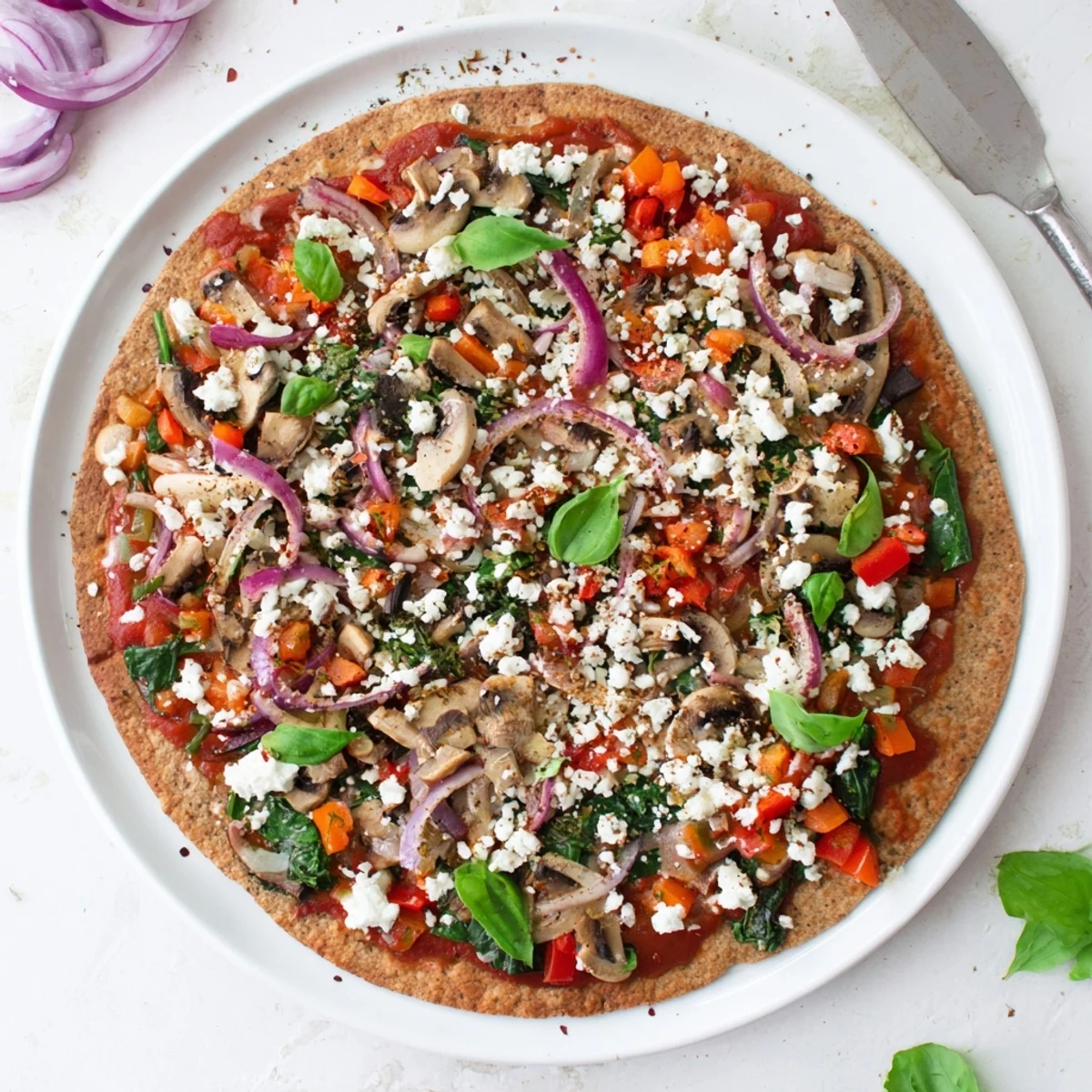 Golden brown whole wheat low cholesterol pita pizza topped with colorful bell peppers, tomatoes, and melted mozzarella cheese on a wooden board
