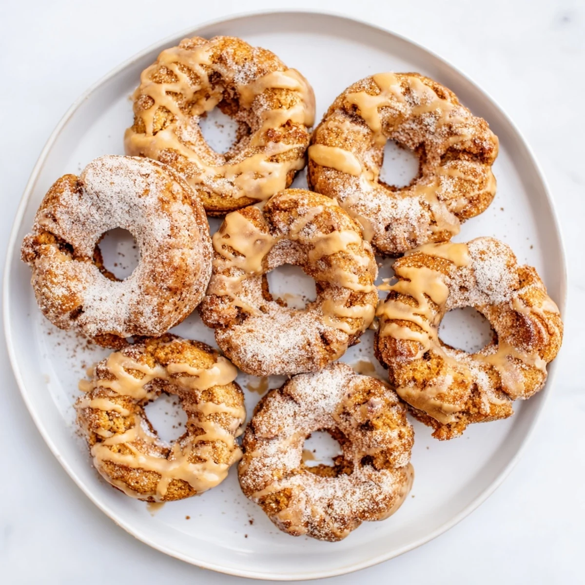 Soft baked banana bread donuts fresh from the oven on a wire cooling rack
