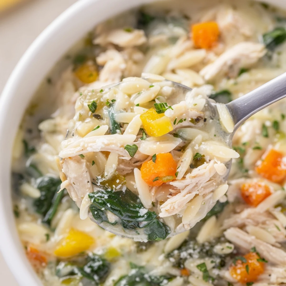 Creamy Chicken Florentine Soup With Orzo steaming in bowl, velvety broth and spinach
