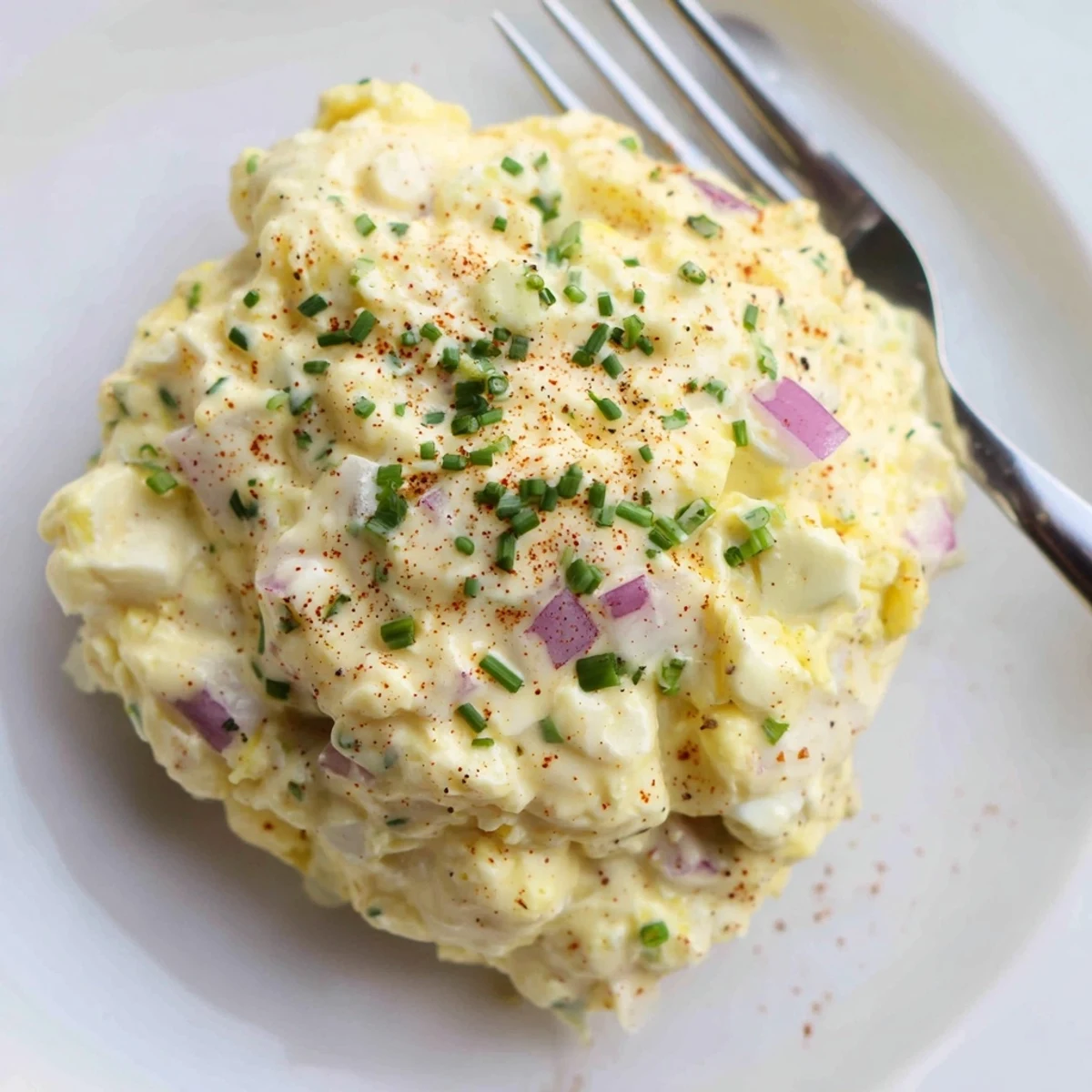 A bowl of Classic Egg Salad Recipe chilled, chunky, with crisp celery