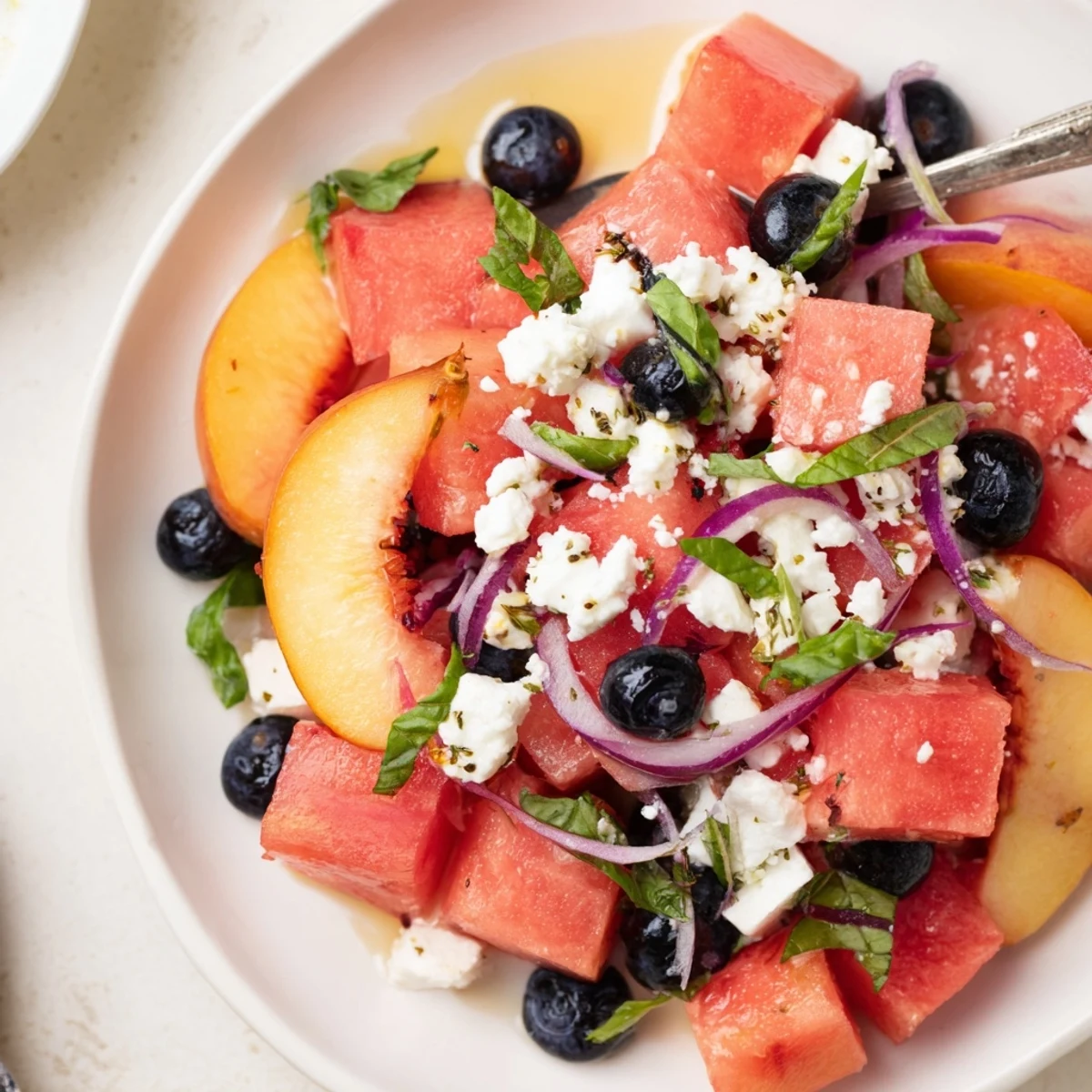 Chilled Peach Watermelon Salad With Feta tossed gently, bright lime dressing, fresh basil