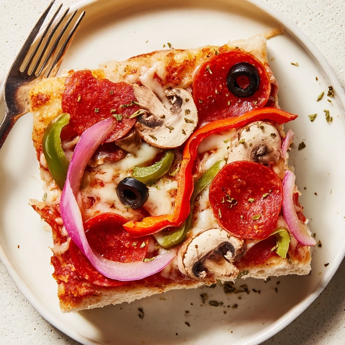 Warm Focaccia Pizza Supreme with golden edges, melted cheese and sliced olives