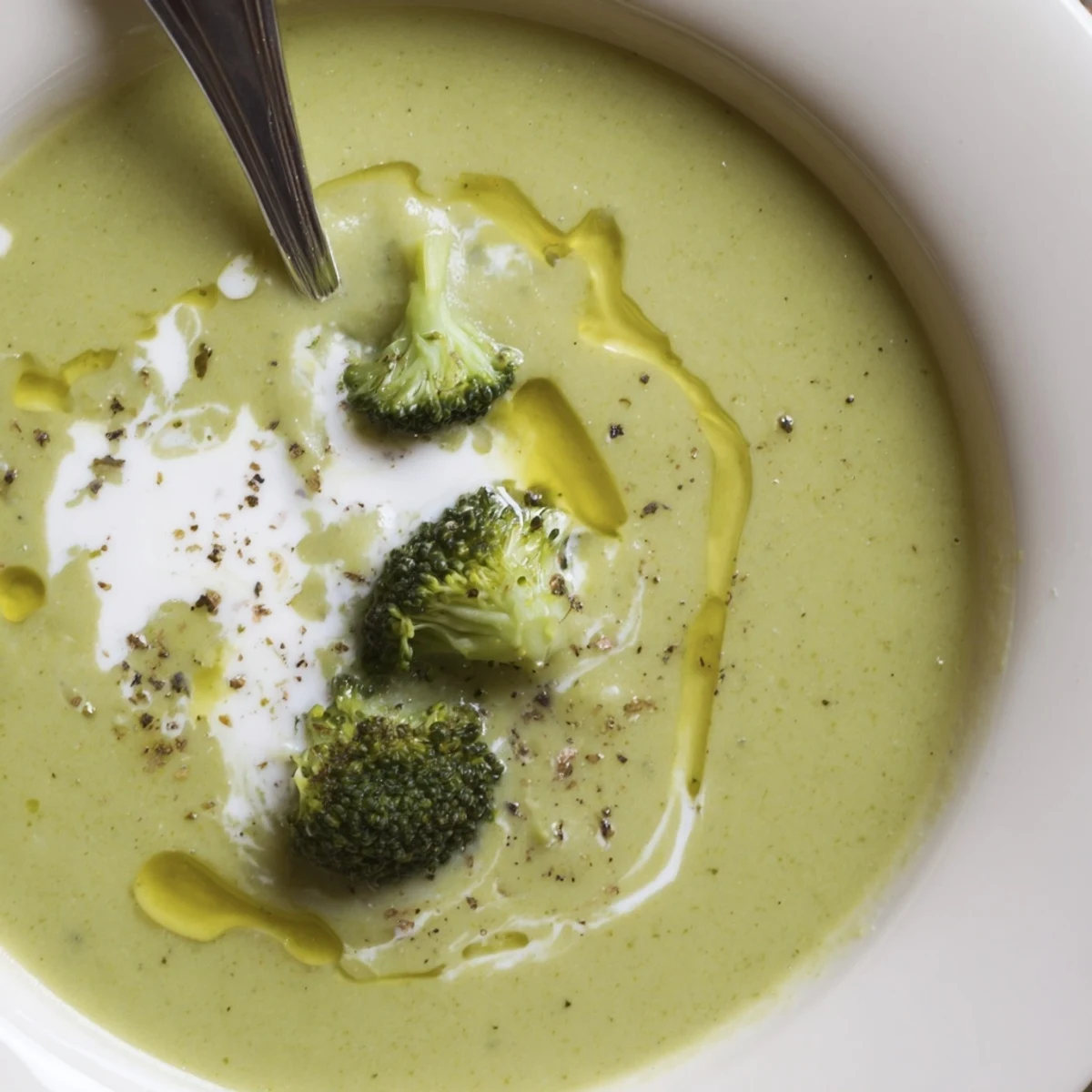 Silky Broccoli Soup blended with garlic and nutmeg, steaming on stove