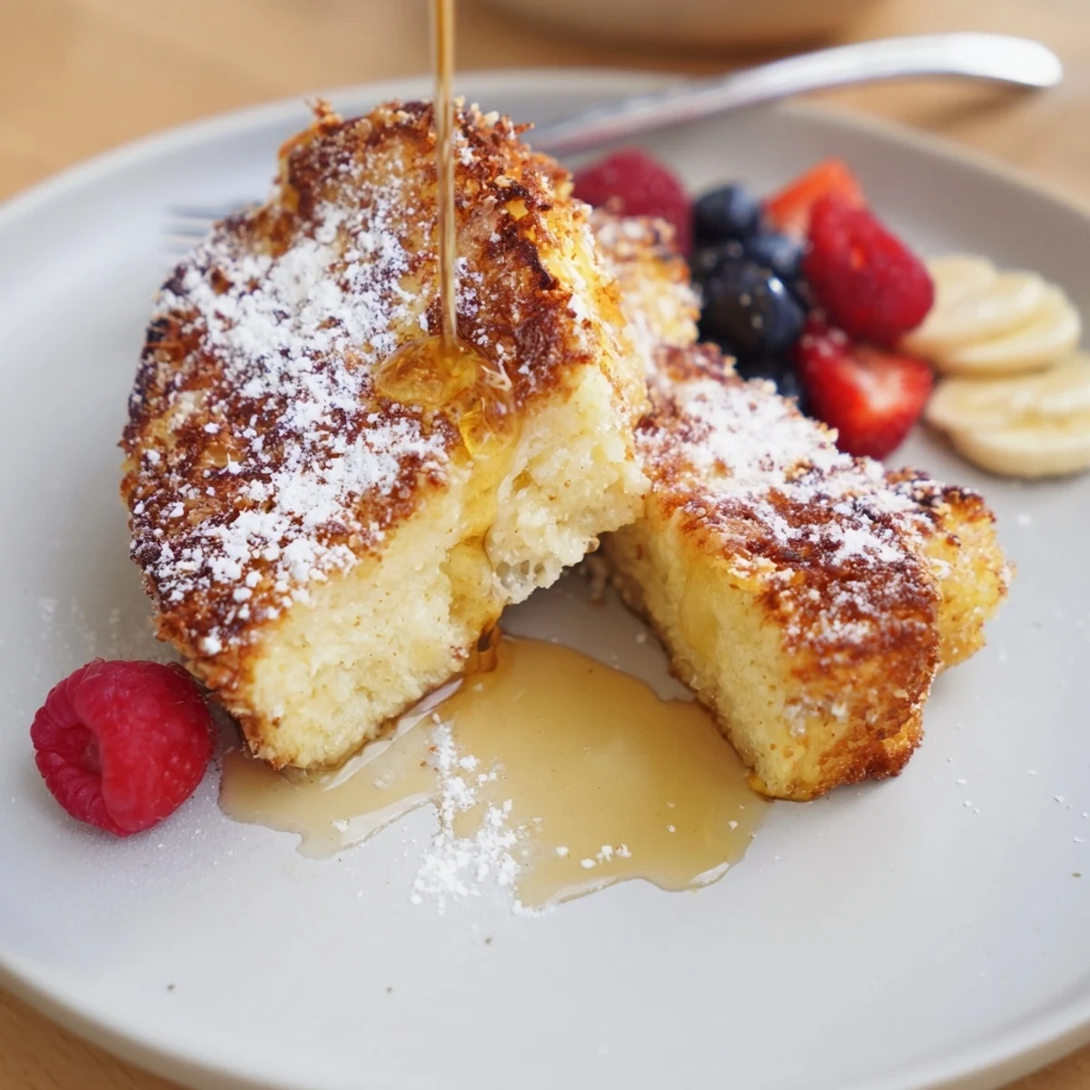 Coconut Crusted French Toast with golden crispy edges, served with maple syrup