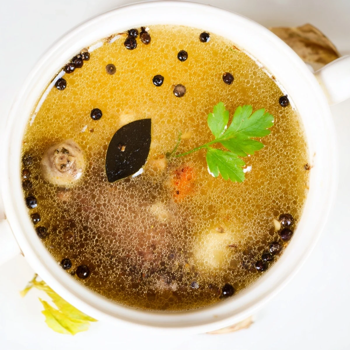 Beef Bone Broth steaming in a pot, golden, savory aromatics rising