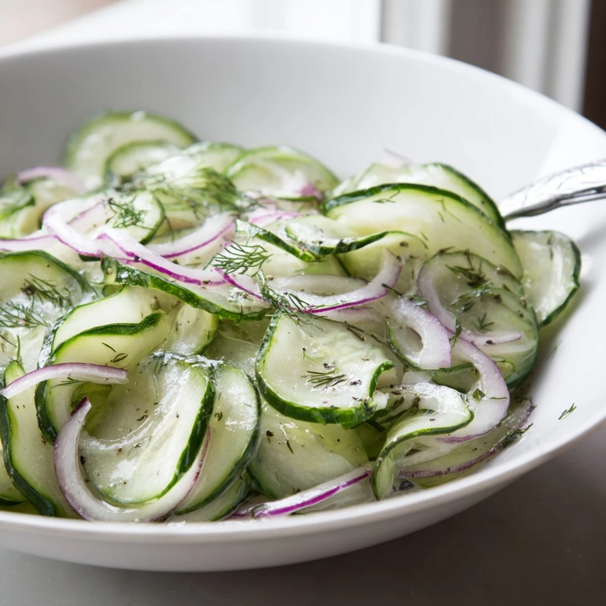 Cucumber Salad glistening with dill and vinaigrette, chilled bowl ready to serve