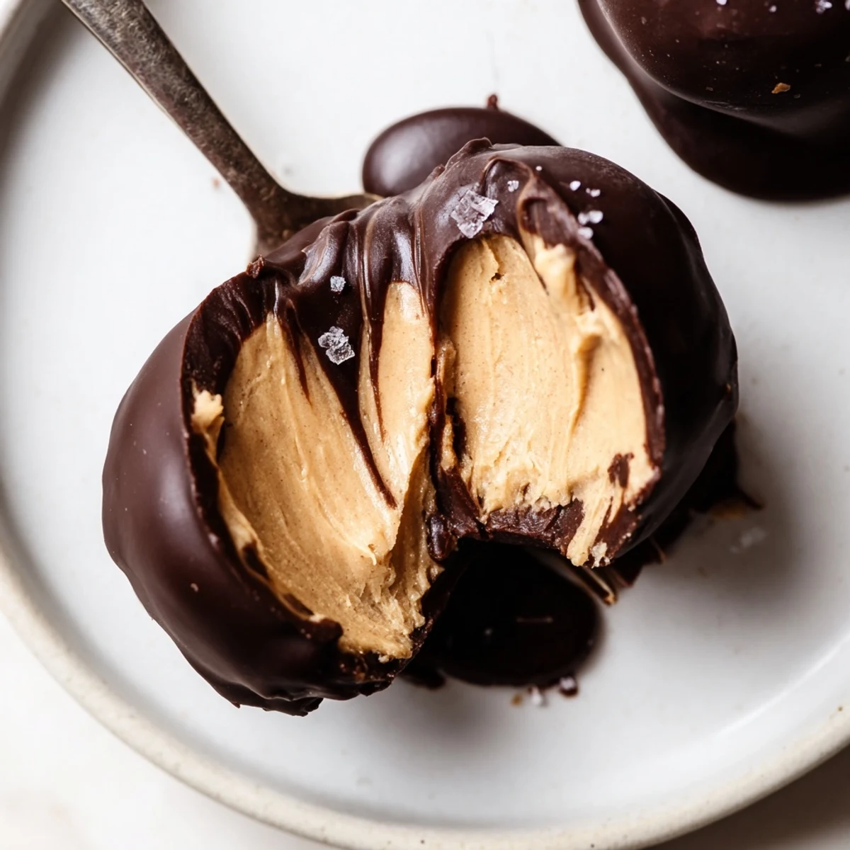 Plated Frozen Peanut Butter Greek Yogurt Bites Dipped In Dark Chocolate With Sea Salt