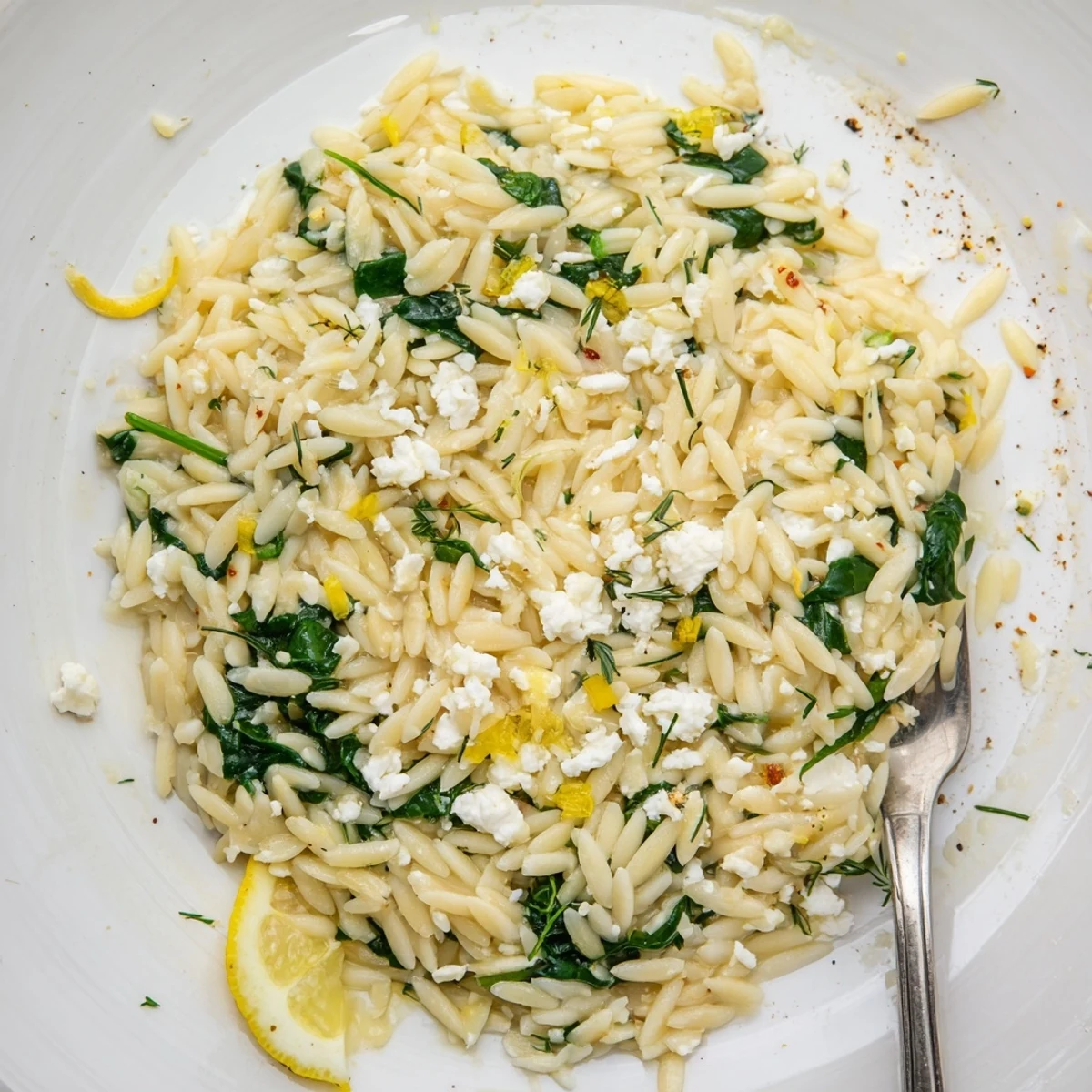 Skillet of One Pan Lemon Orzo With Spinach Feta, creaminess from crumbled cheese