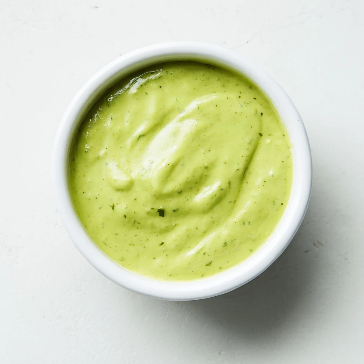 Thick and tangy creamy cilantro lime sauce spooned over a fresh Mexican street corn salad