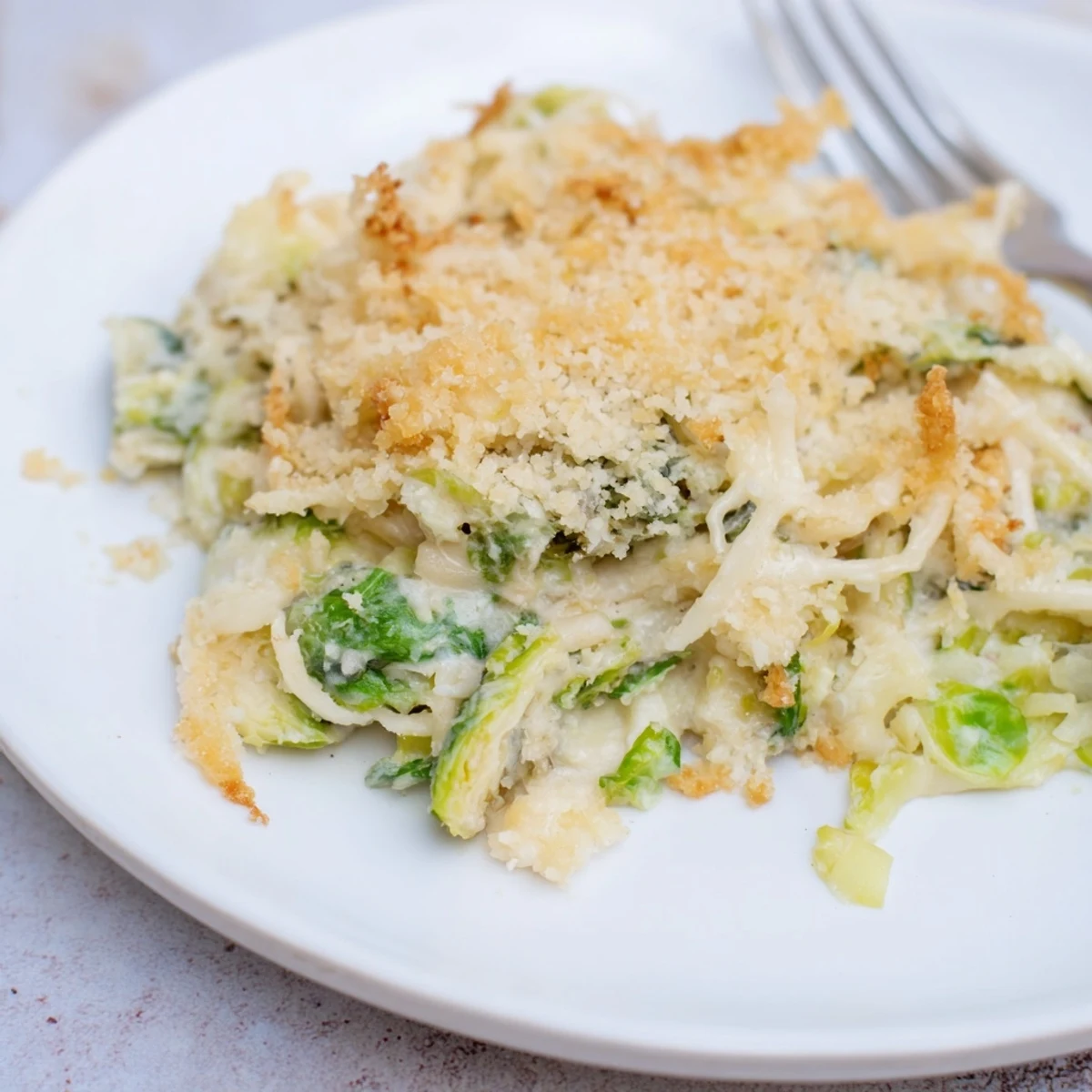 Creamy Parmesan Brussels Sprouts Casserole bubbling with golden breadcrumb crust, savory aroma.