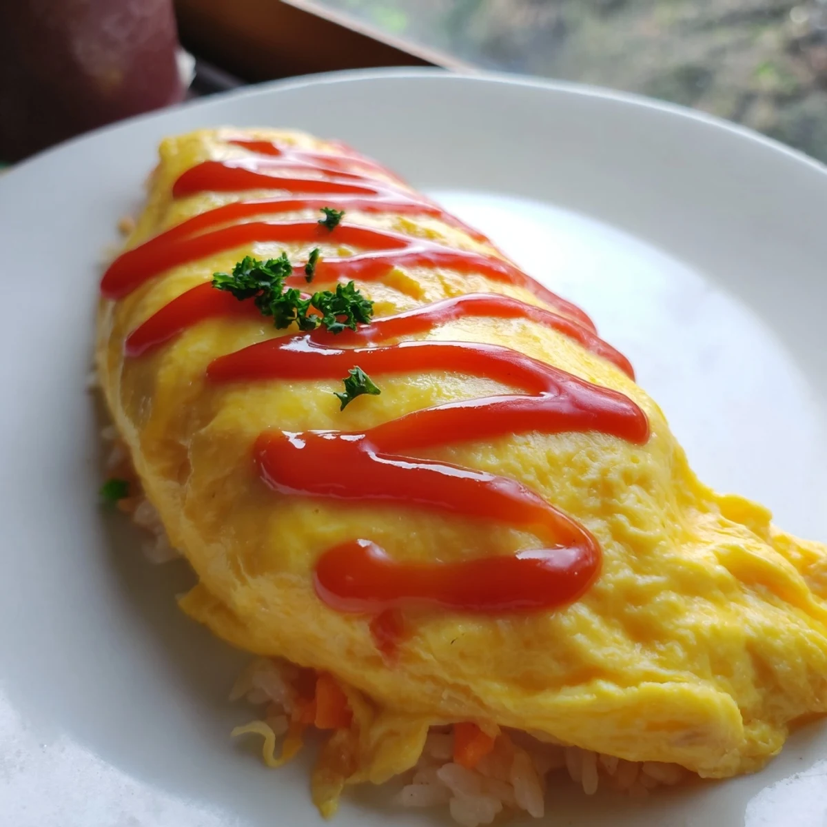 Steaming omurice plated on white dish, fluffy eggs blanket savory chicken fried rice warmly