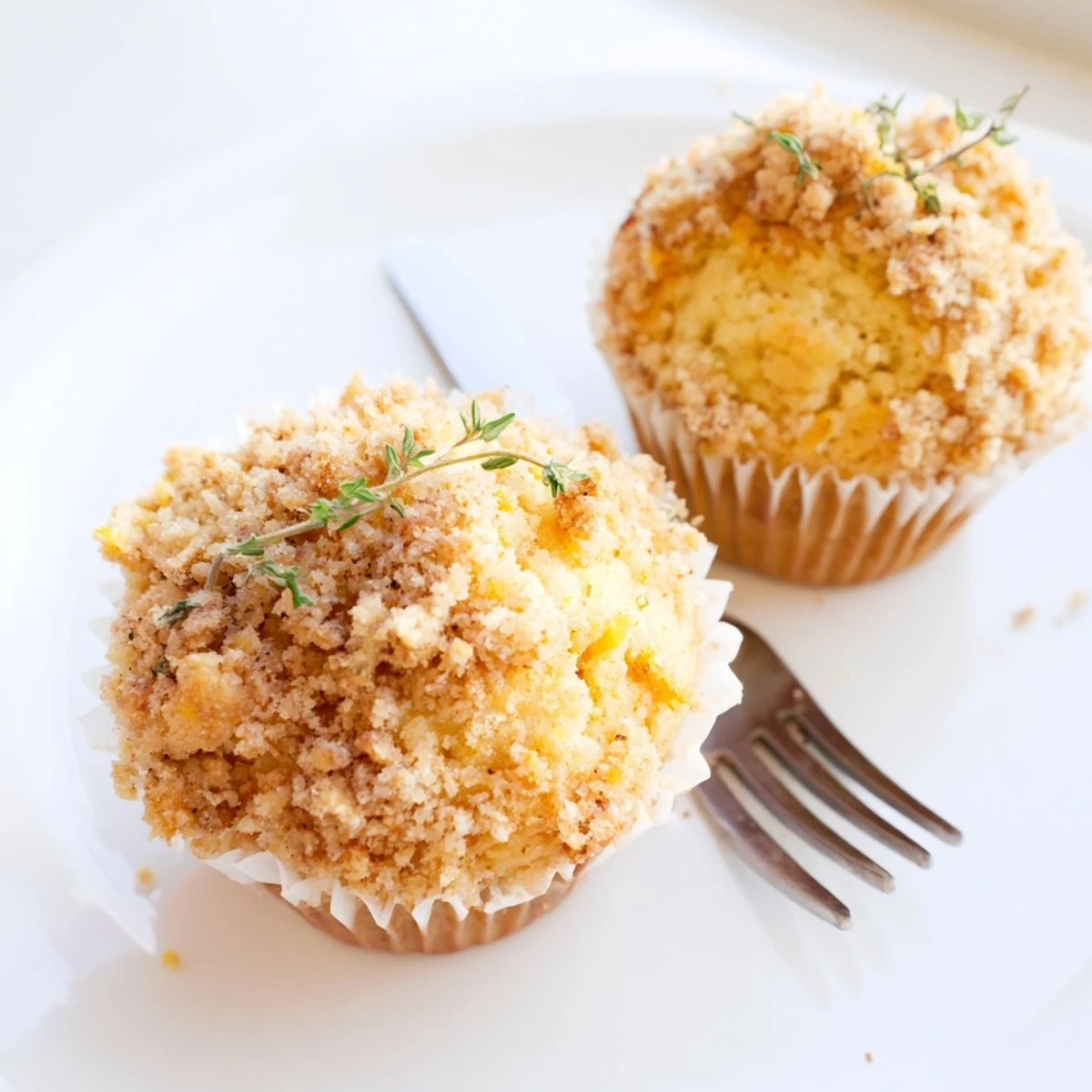Warm lemon orange honey muffins crowned with a savory herb-studded crumble topping ready to serve