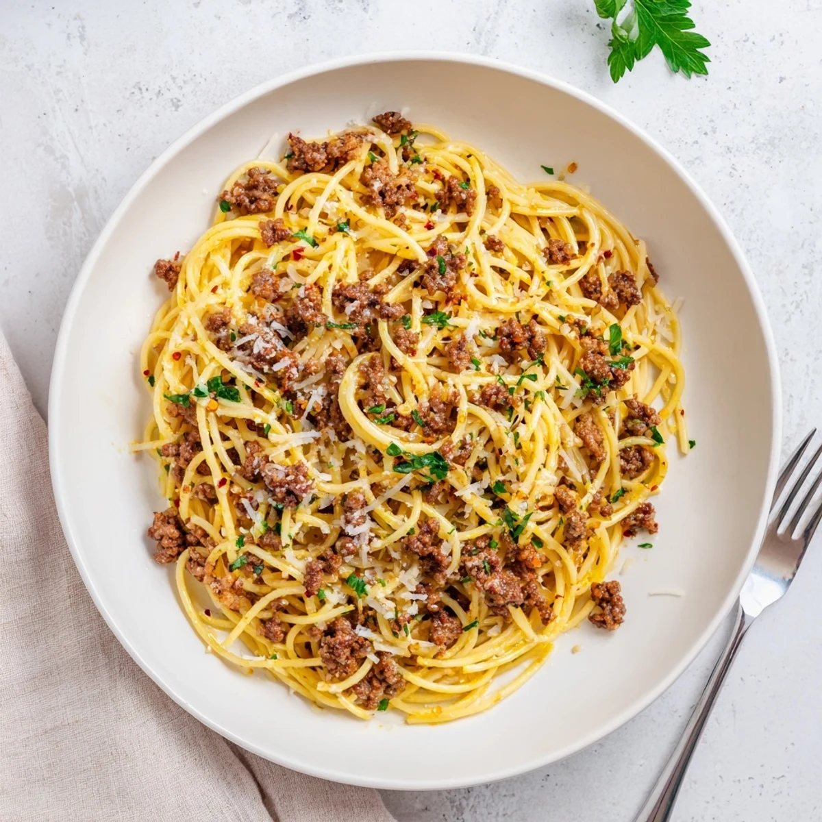 Garlic butter pasta with ground beef coated in a rich golden butter sauce