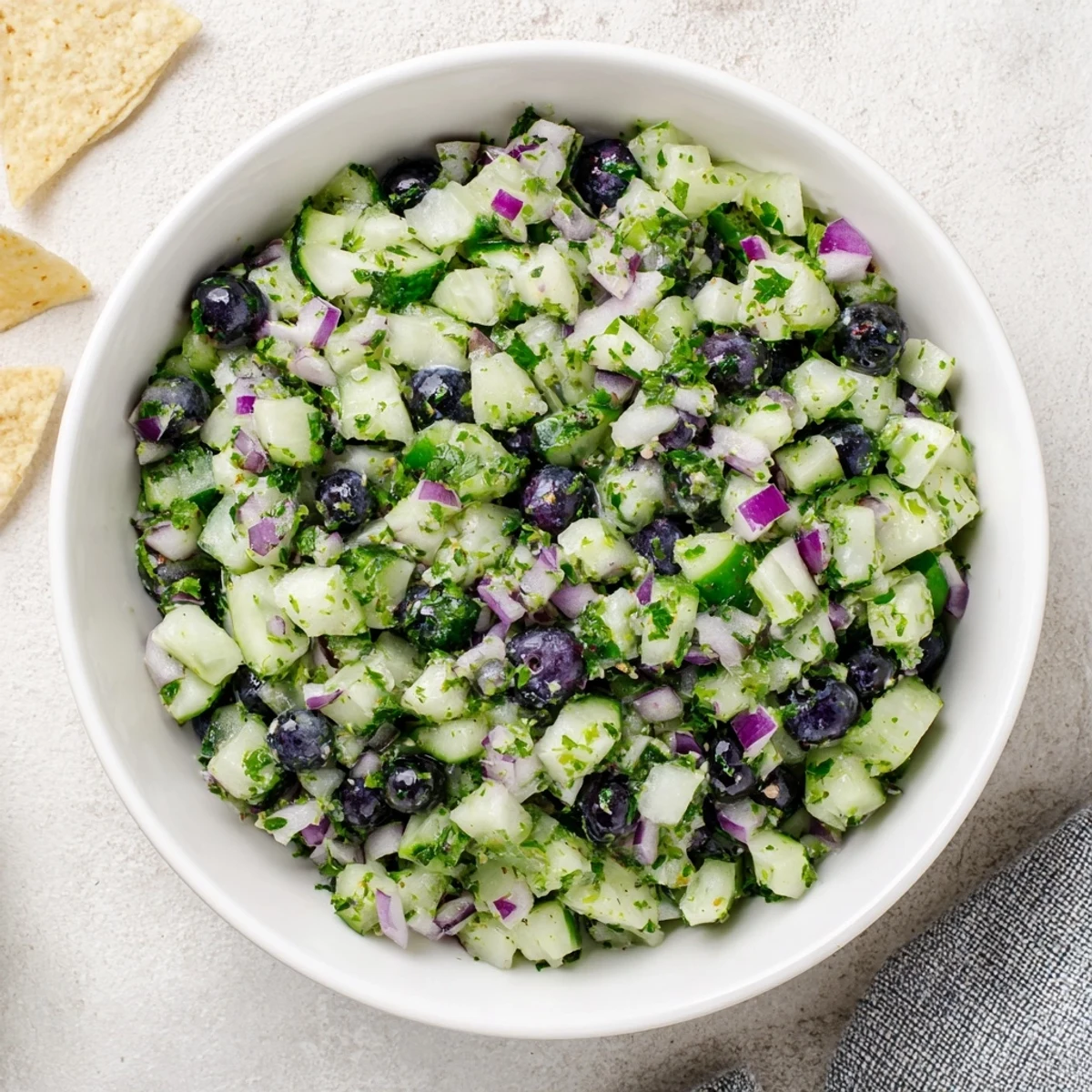 Blueberry cucumber salsa in a bright bowl bursting with juicy berries and crisp veggies