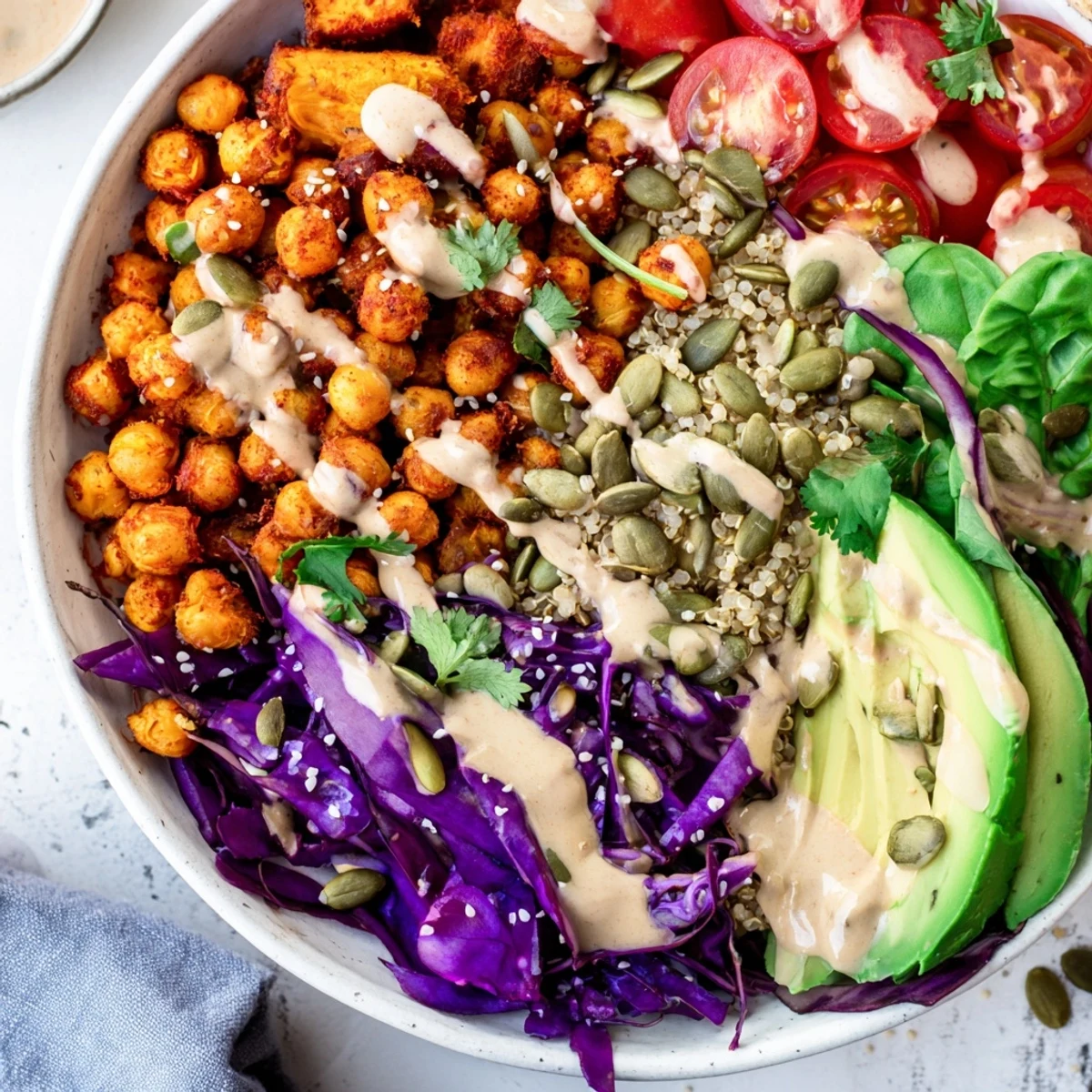 Vibrant Buddha Bowl served on rustic wood with avocado and toasted sesame seeds