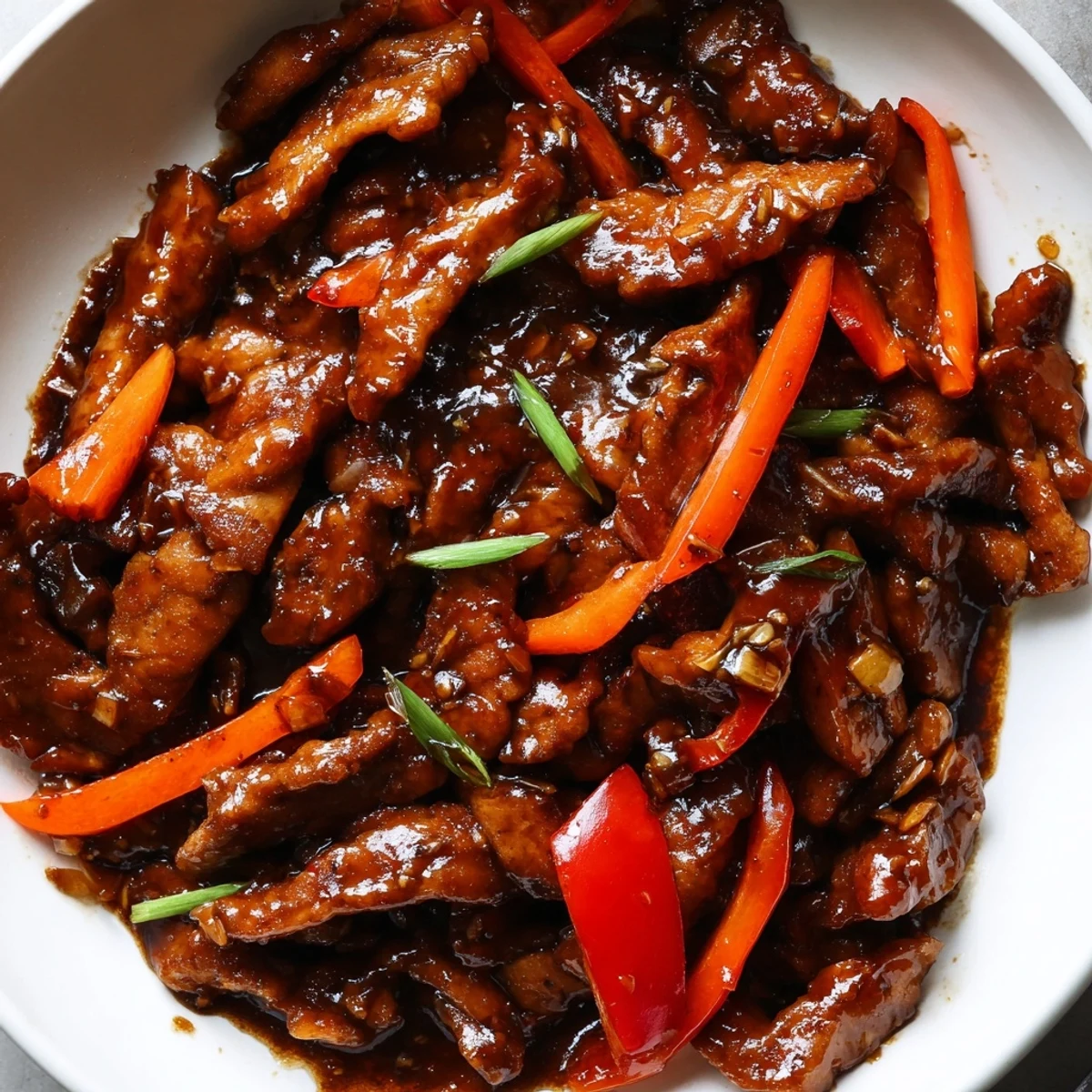 Glossy stir fried Chinese garlic chicken with crisp bell peppers and steamed white rice