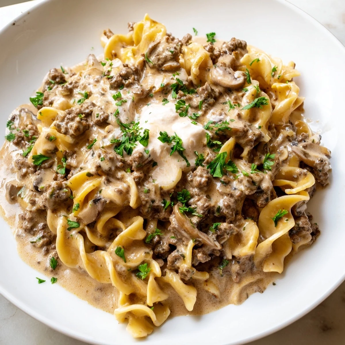 Hearty hamburger stroganoff with creamy sauce served over tender egg noodles