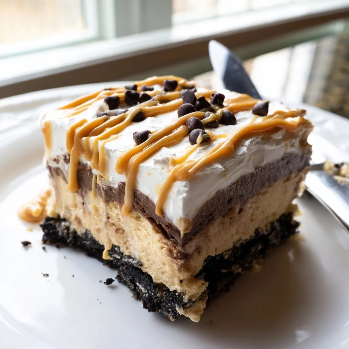 Peanut butter layered delight sliced into neat squares revealing luscious creamy layers