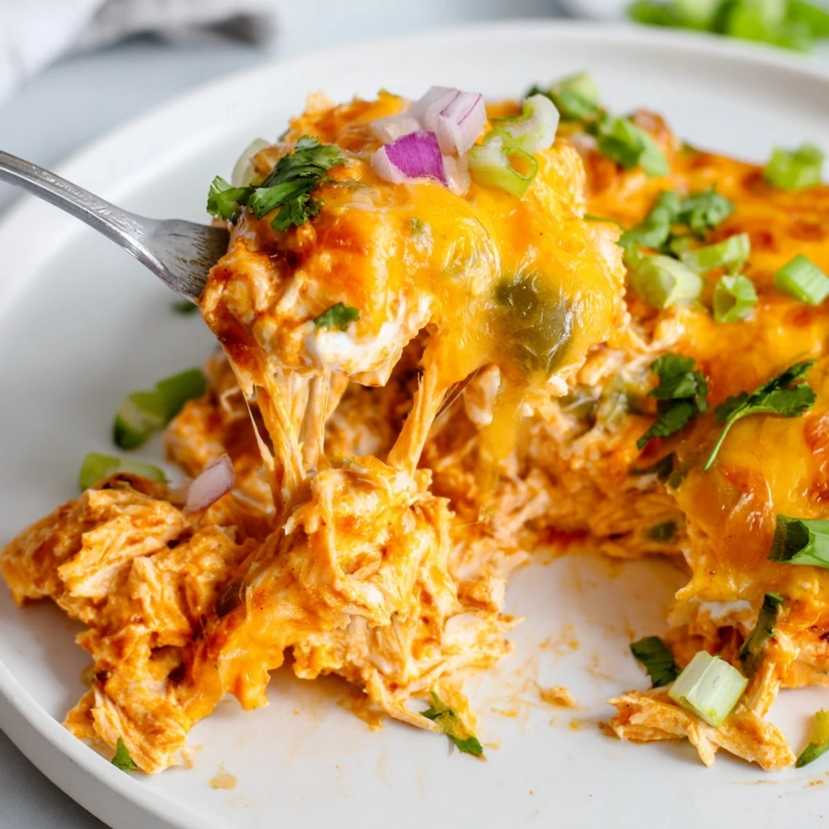 Golden bubbling jalapeno buffalo chicken casserole fresh from the oven with melted cheddar topping