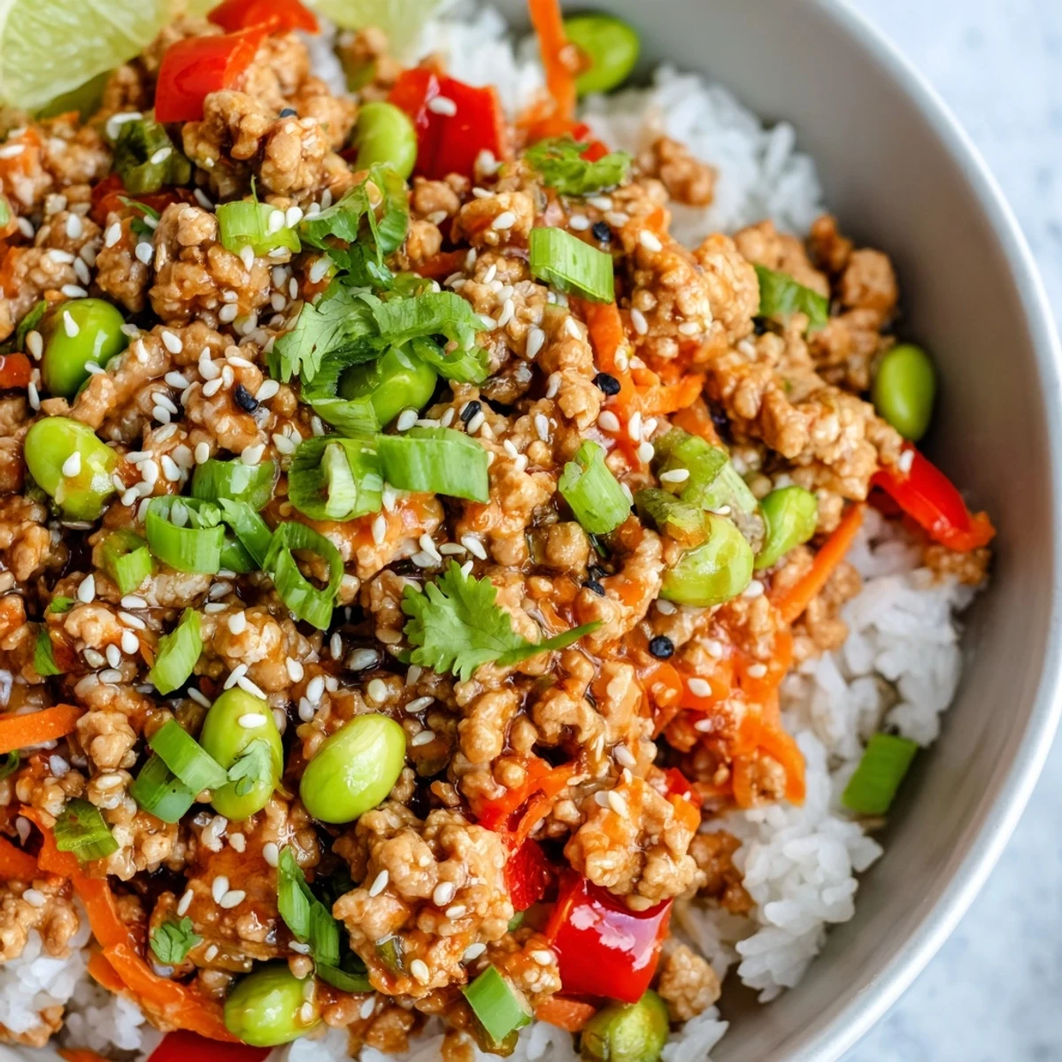 Colorful ground turkey rice bowls with sautéed bell peppers, shredded carrots, and fluffy white rice