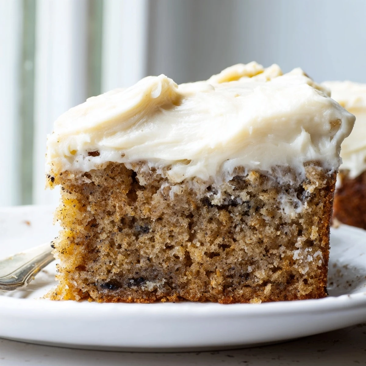 A golden Brown Butter Banana Cake topped with pillowy cream cheese frosting