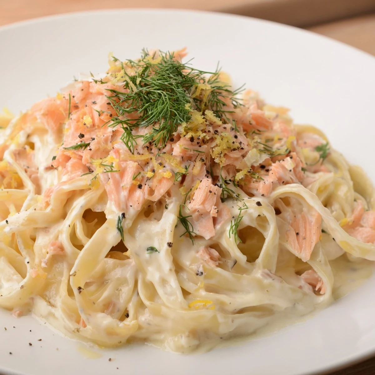 Creamy hot smoked salmon pasta recipe with flaky fish in a rich white sauce.  